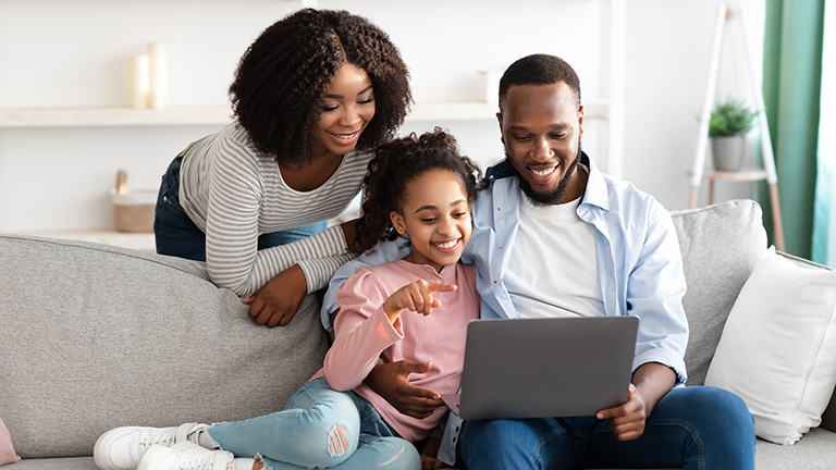 happy family on laptop smiling